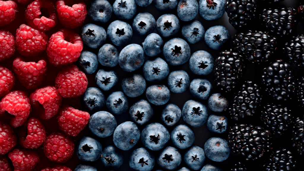Top view of raspberries, blueberries and blackberries - foods that help with bloating