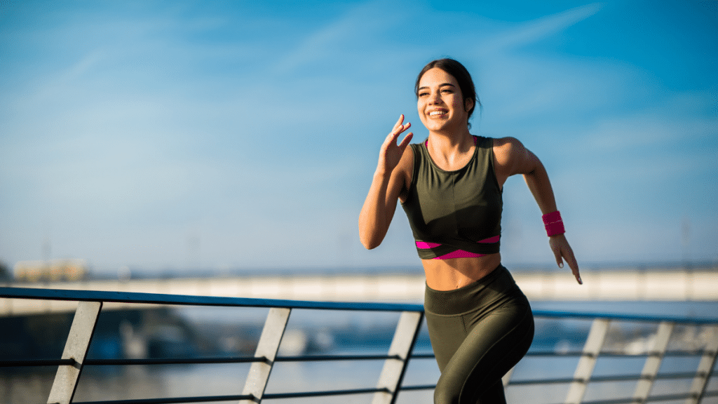 woman running 2 miles a day and smiling because it improves her mood 