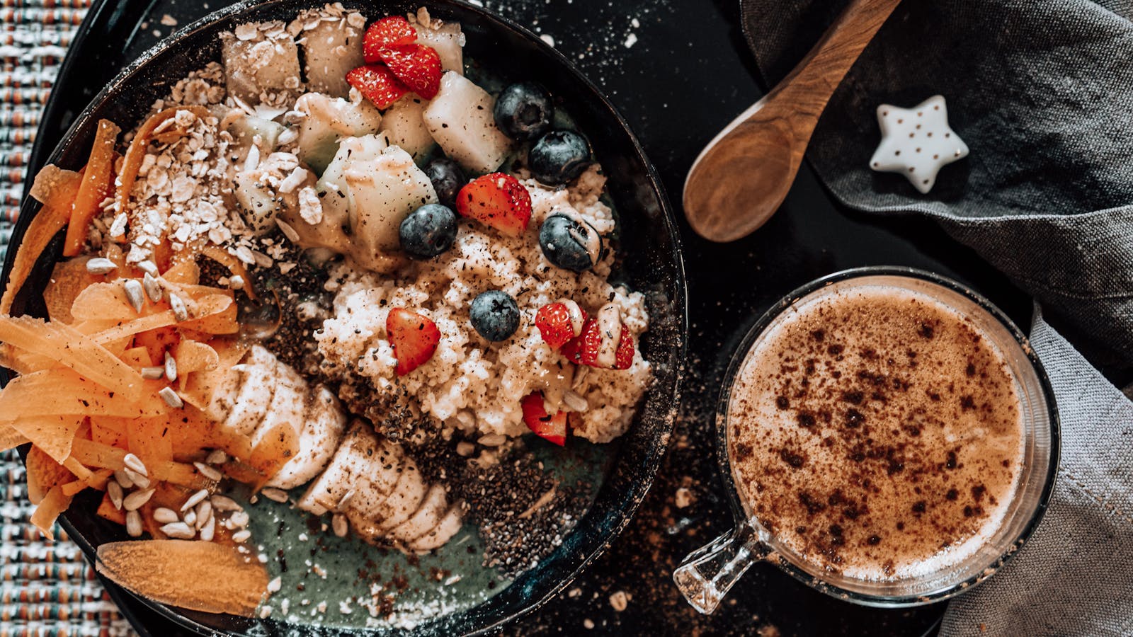 Oatmeal breakfast bowl with fresh fruits and a cup of coffee