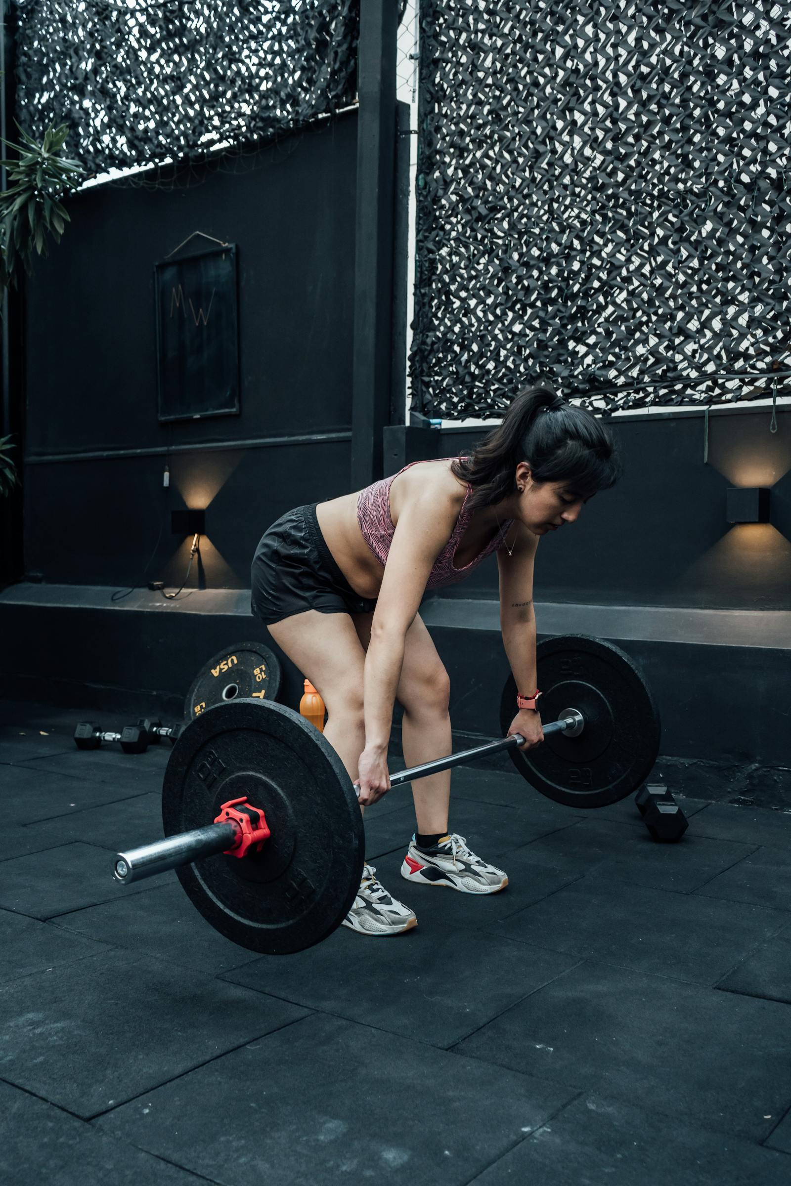 Woman performing a dumbbell Romanian deadlift