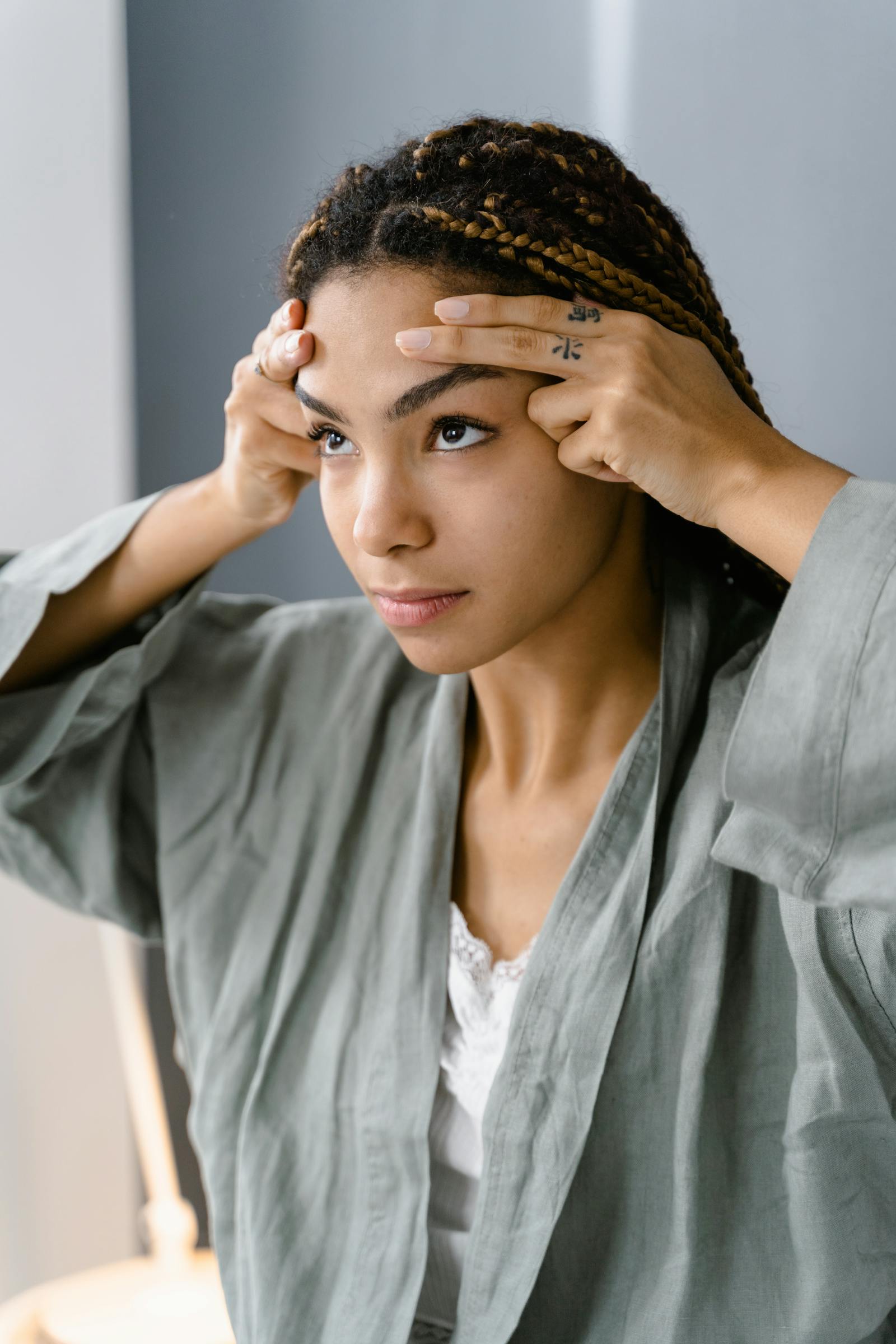 Young woman doing facial massage for skin care